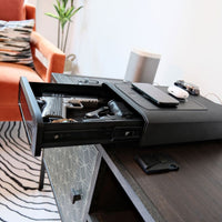 Vaultek DS5i Smart Station ViSN Biometric with handguns and accessories in secure drawer on a stylish table.
