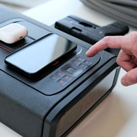 Vaultek DS5i Smart Station ViSN Biometric with smartphone, pistol, and wireless charging features.