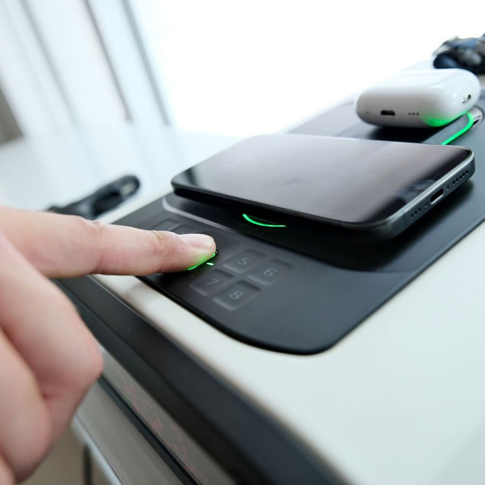 User activating the Vaultek DS5i Smart Station ViSN Biometric with a smartphone on top.