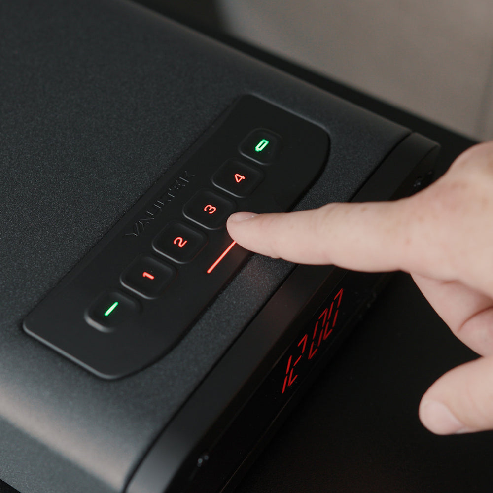 Vaultek DS2e Smart Station Safe keypad with a finger pressing the number button for access.