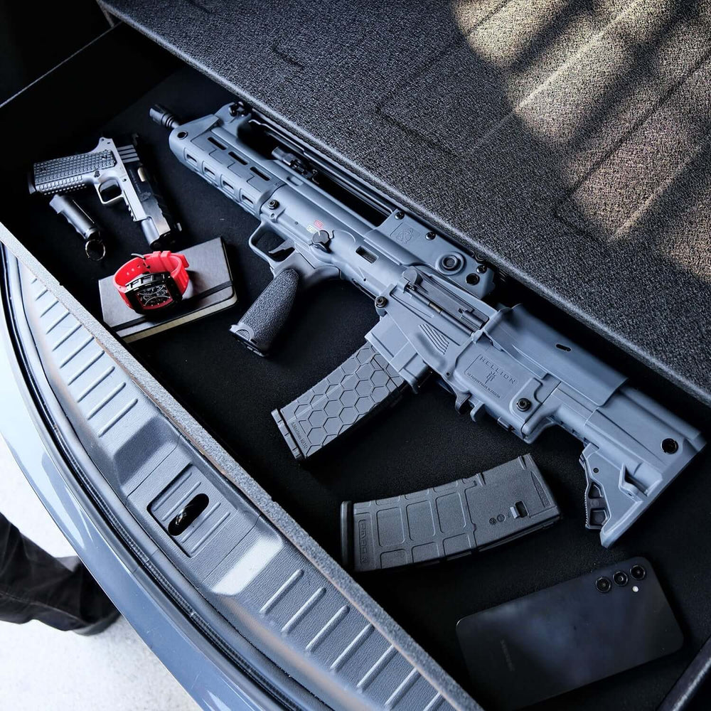 Vaultek RS Slider ViSN Biometric Safe showcasing AR style rifles and accessories in a vehicle trunk.