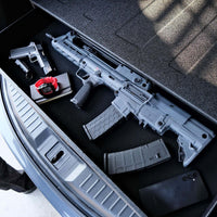 Vaultek RS Slider ViSN Biometric Safe showcasing AR style rifles and accessories in a vehicle trunk.