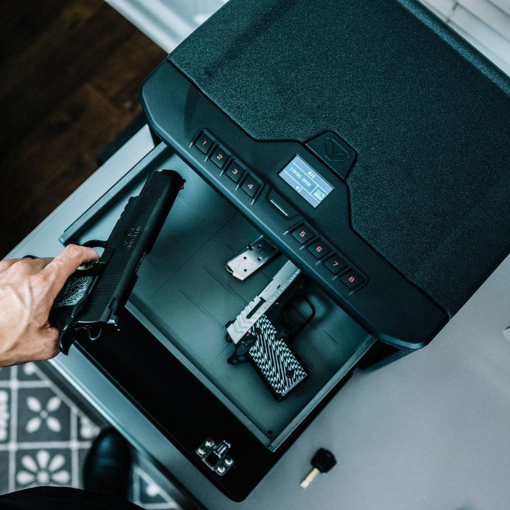 Person accessing a Vaultek MR Series Essential Safe with handguns inside.