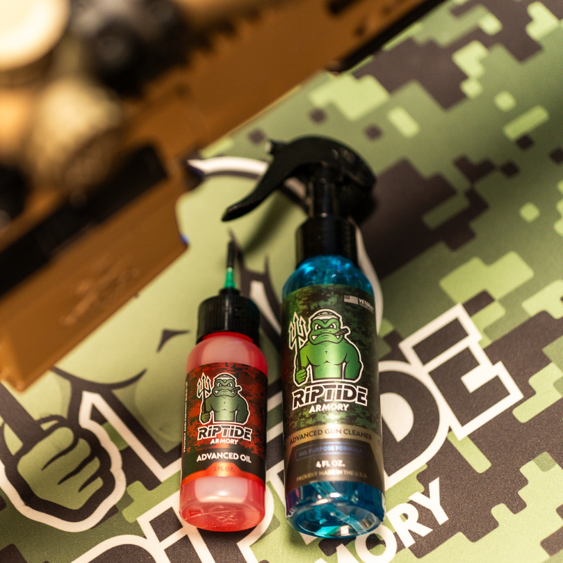 Riptide Armory Advanced Gun Cleaner & Advanced Oil 2 Step Kit displayed on a camo background, including spray and bottle.
