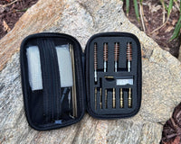 Riptide Gun Cleaning Bundle contents displayed in a compact case on a rocky surface.